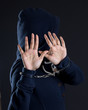 Women in handcuffs avoiding being photographed