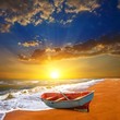 small boat on a sea coast at the sunset small boat on a sea coast at the sunset