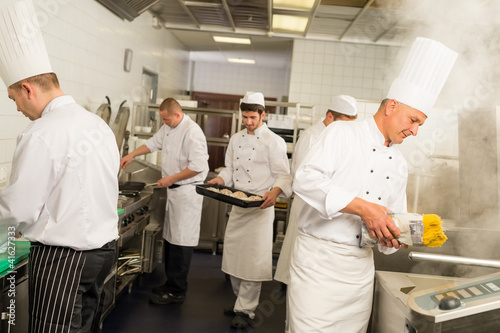 Photo: Professional kitchen busy team cooks and chef Professional kitchen busy team cooks and chef