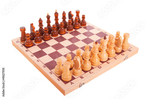Photo: Chess on a chess board isolated over white Chess on a chess board isolated over white