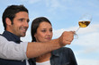 Couple tasting wine outdoors