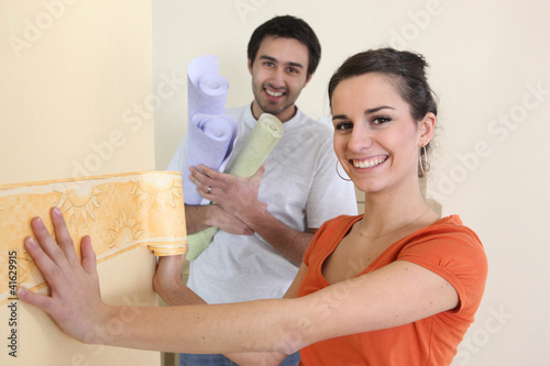 Photo: Couple wallpapering Couple wallpapering