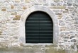 old dark green wooden door on stone wall