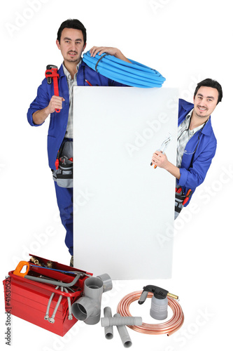 Photo: Plumber with a board left blank for your message Plumber with a board left blank for your message
