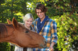 Couple petting horse