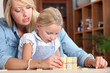 Woman and child playing dominoes