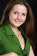 Portrait of young woman in green shirt.