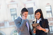 Business couple outdoors with tablet.