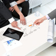 Hands on papers at business meeting.