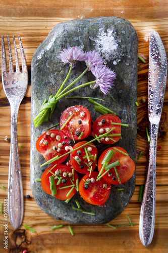 Photo: Cherry tomatoes on flat stone Cherry tomatoes on flat stone