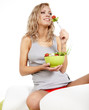 Healthy lifestyle - smiling woman with vegetable salad on white