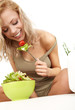 Healthy lifestyle - smiling woman with vegetable salad on white