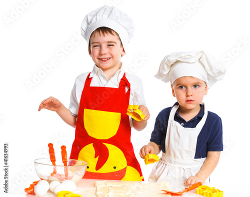 Photo: Two beautiful caucasian brothers making a cake Two beautiful caucasian brothers making a cake