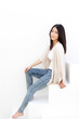 attractive young woman sitting on white stair