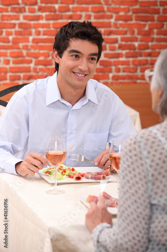 Photo: a boy and his grandmother at restaurant a boy and his grandmother at restaurant