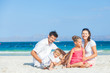 Family of four on tropical beach