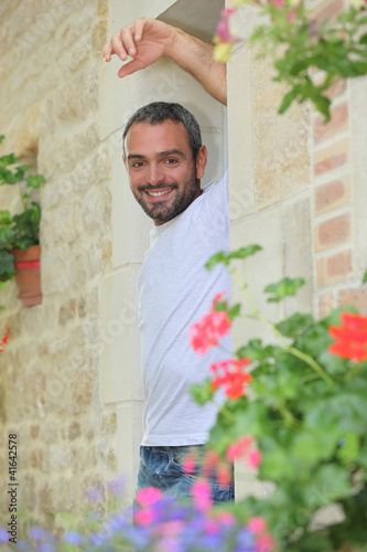Photo: Man leaning on a door Man leaning on a door