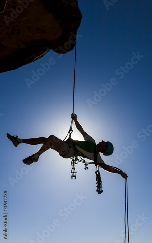 Photo: Climber rappelling from the summit. Climber rappelling from the summit.