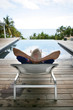 Senior man relaxing poolside