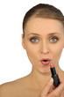 Woman applying lipstick