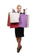 Young business woman in a black suit holding shopping bags Young business woman in a black suit holding shopping bags