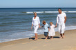 Family with children walking on the beach
