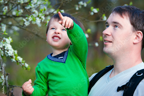 Photo: Father and his little son in spring park Father and his little son in spring park