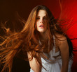 Beautiful woman with long flowing hair on a red background Beautiful woman with long flowing hair on a red background