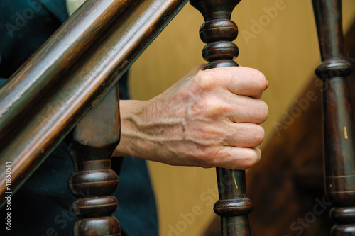 Photo: old woman wrinkled hands hold the handrail old woman wrinkled hands hold the handrail