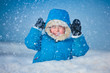 Portrait of a little boy playing in the snow
