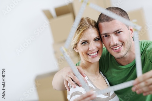 Photo: Young couple moving in new house Young couple moving in new house