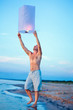 A young man with a fire lantern