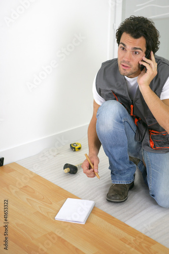 Photo: Man laying a wooden floor Man laying a wooden floor