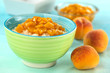 Colorful bowl full of rice pudding with peach compote