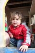 Little boy playing in garden shed