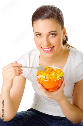 Photo: Young woman with fruit salad Young woman with fruit salad