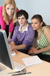 Teenagers looking at a computer screen