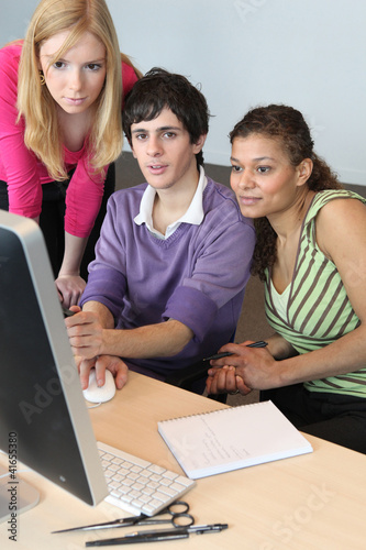 Photo: Teenagers looking at a computer screen Teenagers looking at a computer screen
