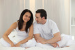 Couple sitting on a bed Couple sitting on a bed