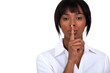 African American woman shushing. African American woman shushing.