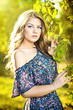 Young attractive girl with blue dress outdoor on the field