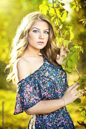 Photo: Young attractive girl with blue dress outdoor on the field Young attractive girl with blue dress outdoor on the field