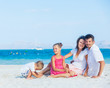 Family of four on tropical beach Family of four on tropical beach