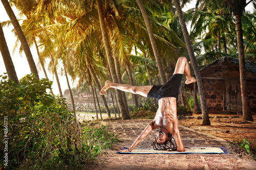 Photo: Yoga handstand pose in tropic Yoga handstand pose in tropic