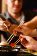 Young people eating in Thai restaurant