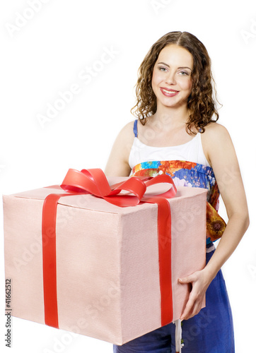 Photo: The beautiful girl smiling holds a gift in a box The beautiful girl smiling holds a gift in a box