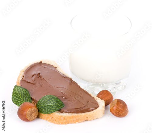 Photo: Chocolate spread container with a buttered toast, nuts and milk Chocolate spread container with a buttered toast, nuts and milk