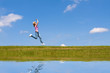 Woman jumps on the meadow