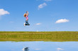 Woman jumps on the meadow