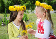 Portrait of a little girls in wreaths of flowers